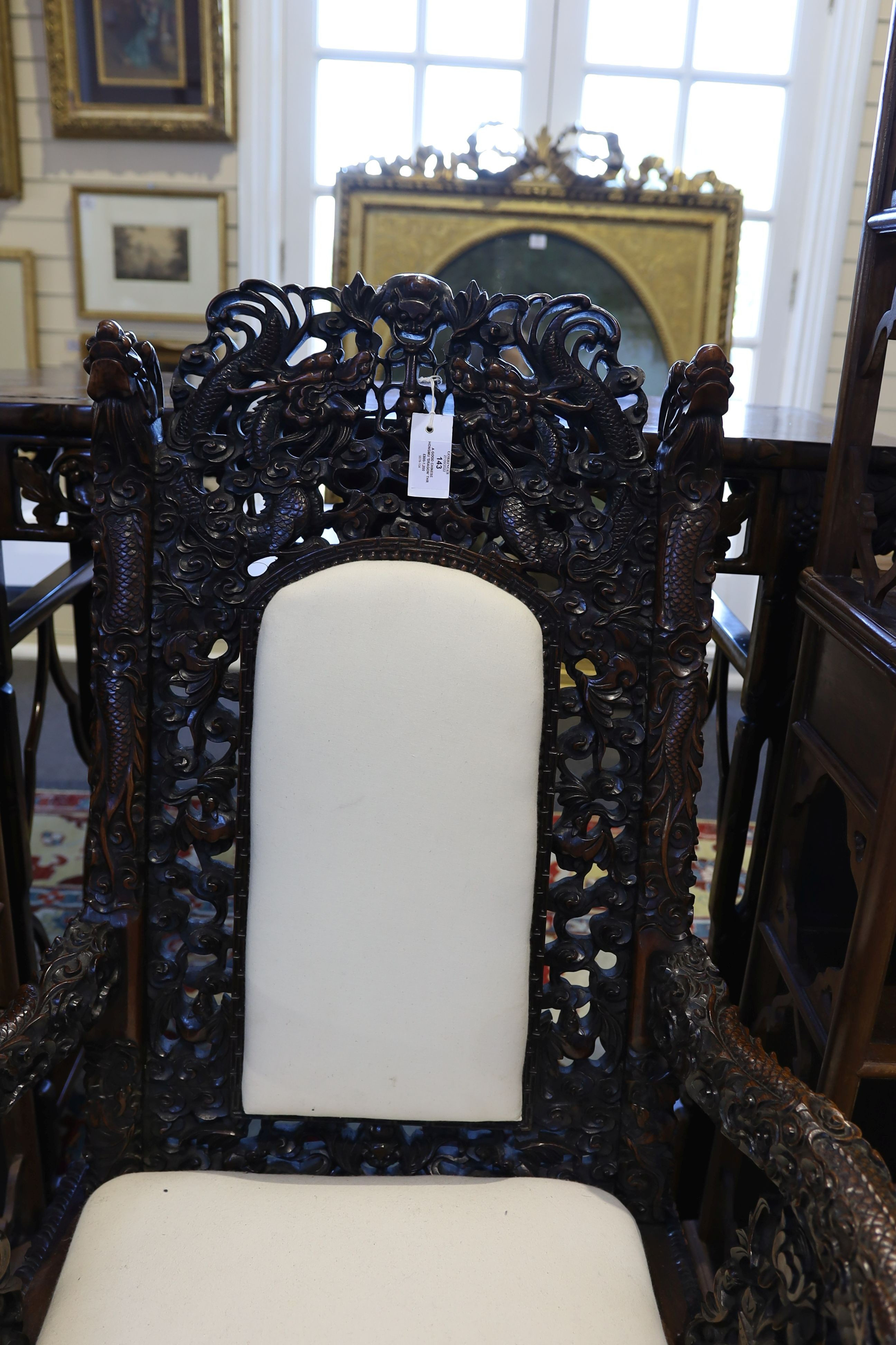 A good Chinese hardwood ‘dragon’ throne armchair, c.1900, 114.5cm high, 68cm wide at the arms